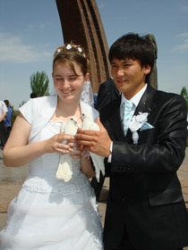 Genna and Rakhat prepare to release doves as part of the Kyrgyz wedding festivities.