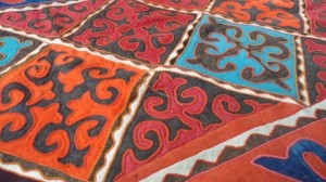 A handmade shyrdak rug with the deisgn meaning the “leather vessel for kymyz” (Kymyz is a traditional Kyrgyz drink made from fermented mare’s milk.
