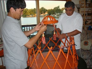 Rakhat and his father assembling the miniature yurt for the wedding.