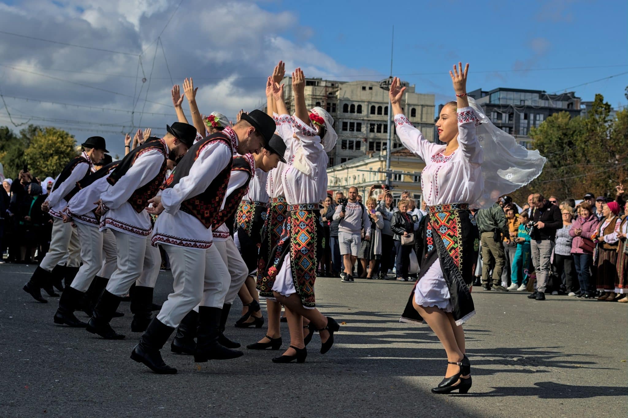 Folk artists in national costumes perform at a free open festival celebrating National Wine Day.