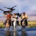 group of Kazakh eagle hunters riding horses crossing river