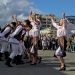 Folk artists in national costumes perform at a free open festival celebrating National Wine Day.
